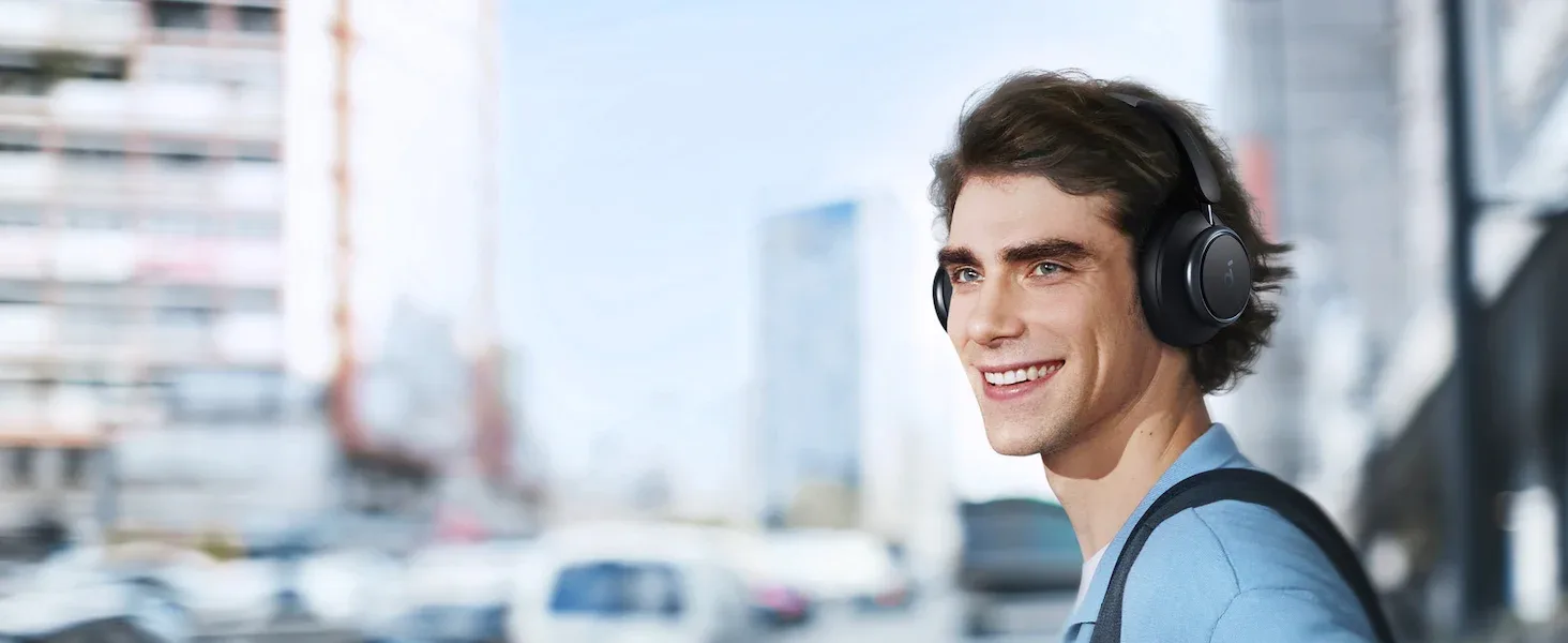 Man wearing black Soundcore Space Q45 headphones on a city street